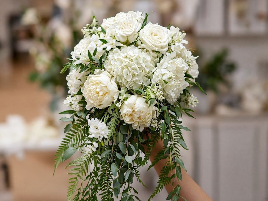 Cascading bridal bouquet with trailing greenery